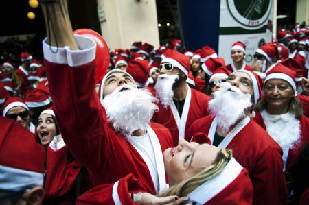 Photo for GREECE, Athens : Runners wearing Santa Claus costumes take part in the second Athens 'Santa Claus Run' in city's center on November 29, 2015. - Royalty Free Image