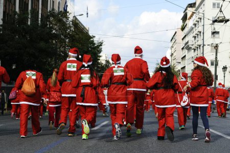 Photo for GREECE, Athens : Runners wearing Santa Claus costumes take part in the second Athens 'Santa Claus Run' in city's center on November 29, 2015. - Royalty Free Image