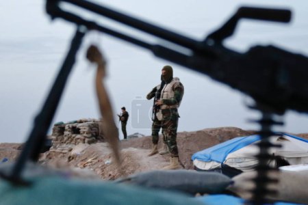 Téléchargez les photos : IRAQ, Gwer: Peshmerga fighters hold a position on the frontline in the Gwer district, 40 kilometres south of Arbil, the capital of the Kurdish autonomous region in northern Iraq, as battles with Islamic State jihadists continue on December 1st, 2015 - en image libre de droit