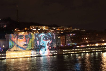 Photo for FRANCE, Lyon: A work from Daniel Knipper is projected on buildings frontage, in Lyon, on December 8, 2015, during the 17th edition of the Festival of Lights, a secular version of a religious tradition devoted to Virgin Mary - Royalty Free Image