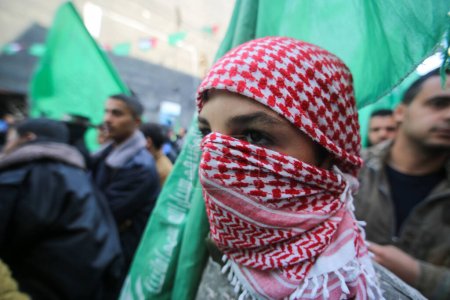 Photo for GAZA, Gaza City: Palestinians and militants of the Ezzedine al-Qassam Brigades, the Hamas' armed wing, take part in a rally marking the 28th anniversary of Hamas' founding, in Gaza City on December 14, 2015 - Royalty Free Image