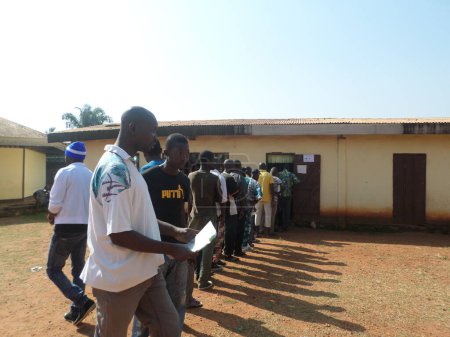 Photo for CENTRAL AFRICAN REPUBLIC, Bangui : Voters queue outside a polling station at the Vie et Espoir school in Bangui on December 13, 2015 - Royalty Free Image