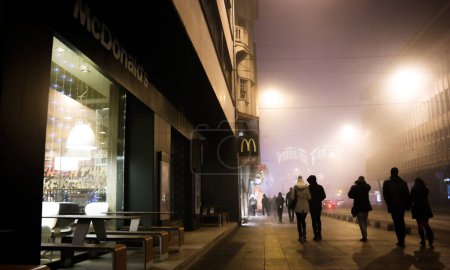 Photo for Bosnia and Herzegovina - Sarajevo - People Walking in The Street During Fog - Royalty Free Image