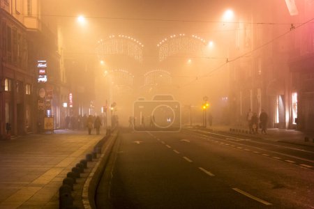 Photo for BOSNIA AND HERZEGOVINA, Sarajevo: People walk around Sarajevo, as heavy pollution covers the city on December 24, 2015. - Royalty Free Image