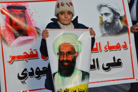Photo for IRAQ, Baghdad: Demonstrators held pictures of Shiite cleric Nimr al-Nimr in Baghdad, Iraq on January 3, 2016.Nimr was killed in Saudi Arabia on January 2, along with 46 others. - Royalty Free Image