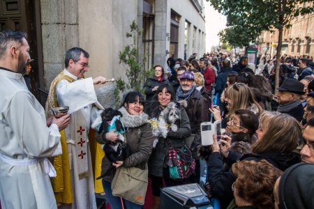Foto de ESPAÑA, Madrid: Sacerdote bendiciendo animales fuera de la iglesia de San Antn en la calle de Hortaleza en Madrid el día de San Antonio, el santo patrón de los animales, el 17 de enero de 2016. - Imagen libre de derechos