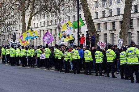 Photo for ENGLAND, London: Protesters march holding banners during a demonstration in London on March 5, 2016, against the closure of borders and violence towards refugees at the Calais camp - Royalty Free Image