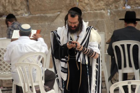 Photo for Jewish men pray at the western wall in Jerusalem - Royalty Free Image