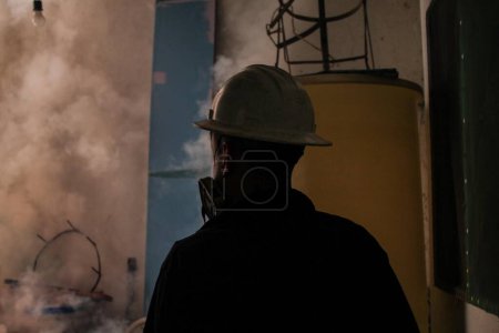 Photo for VENEZUELA, Caracas: A member of a fumigation crew works to exterminate Aedes mosquitoes carrying the rapidly spreading Zika virus in the slums of Caracas, Venezuela on February 3, 2016. - Royalty Free Image