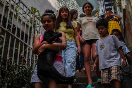 Photo for VENEZUELA, Caracas: Children exit their homes to allow for the extermination of Aedes mosquitoes carrying the Zika virus in the slums of Caracas, Venezuela on February 3, 2016. - Royalty Free Image
