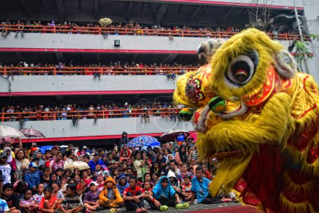 Photo for INDONESIA, Semarang: People gather around to watch the Lion dance, a traditional Chinese dance, on the first day of the Lunar New Year in Kuala Lumpur's popular Chinatown area on February 8, 2016. - Royalty Free Image