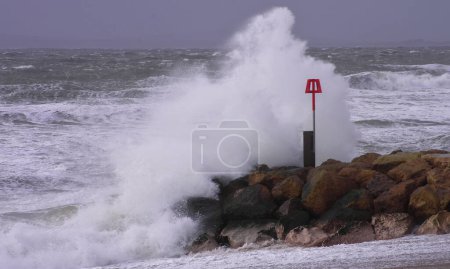 Foto de UK, Dorset: Waves crash on the south coast near Dorset as Storm Imogen batters the UK with winds reaching up to 80mph on February 8, 2016. - Imagen libre de derechos