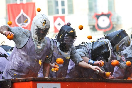 Téléchargez les photos : ITALIE, Ivrée : Les gens se frappent les uns les autres avec des oranges lors de la bataille des oranges à Ivrea, en Italie, le 8 février 2016 - en image libre de droit