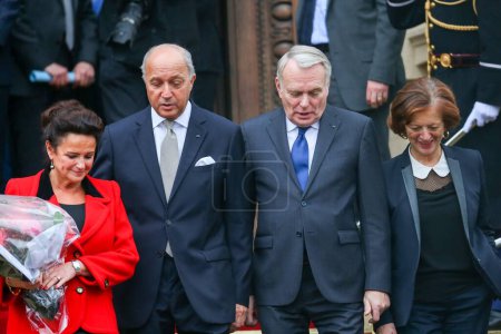 Photo for FRANCE, Paris: Newly appointed French Foreign Minister Jean-Marc Ayrault  escorts France's outgoing Foreign Minister Laurent Fabius and his companion Marie-France Marchand-Baylet on February 12, 2016 in Paris. - Royalty Free Image