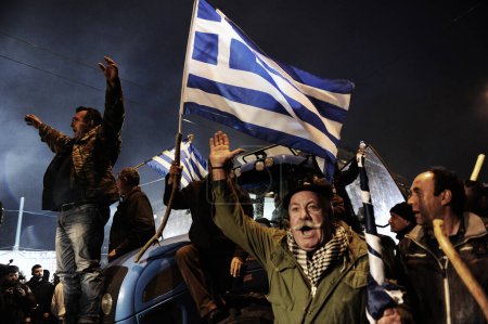 Photo for GREECE, Athens: Angry Greek farmers parade their tractors and pick-ups outside parliament, in their first big protest in the capital against pension reform plans after weeks of road blockades, in Athens on February 12, 2016. - Royalty Free Image
