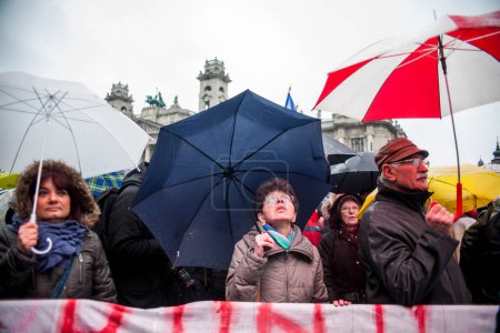 Photo for HUNGARY, Budapest: Participants of a demonstration for teachers, parents and their sympathizers hold banners and umbrellas in front of the parliament building in Budapest downtown on February 13, 2016 - Royalty Free Image