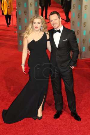 Photo for LONDON, ENGLAND - FEBRUARY 14: Kate Winslet and Michael Fassebender attends the EE British Academy Film Awards at The Royal Opera House on February 14, 2016 in London, England. - Royalty Free Image
