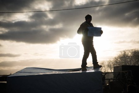 Photo for FRANCE, Calais: makeshift campsite as authorities dismantle the 'Jungle' migrant camp in Calais, France on February 29, 2016. His sign reads: I am searching for freedom in Europe but I find none. - Royalty Free Image