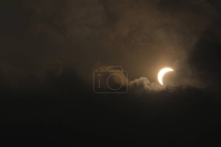 Photo for MALAYSIA, Puncak Alam: A general view shows a partial solar eclipse in Puncak Alam, near Kuala Lumpur, in Malaysia, on March 9, 2016. - Royalty Free Image