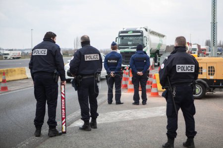 Photo for FRANCE, Neuville-en-Ferrain: French police officers check vehicles at the French-Belgian border, near Neuville-en-Ferrain, northern France, on March 22, 2016 - Royalty Free Image