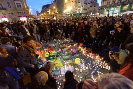 Photo for Belgium, Brussels - March 22, 2016: Thousands gather around a makeshift memorial to pay tribute and mourn the victims of the bomb attacks, at the Place de la Bourse, in Brussels, Belgium - Royalty Free Image