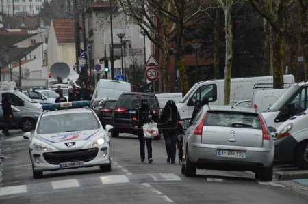 Foto de FRANCIA, Argenteuil: Oficiales de policía caminan en una calle después de una redada en el barrio Argenteuil al noroeste de París el 25 de marzo de 2016. El ministro del Interior francés Bernard Cazeneuve dijo que la policía había arrestado a un sospechoso en el área de París - Imagen libre de derechos