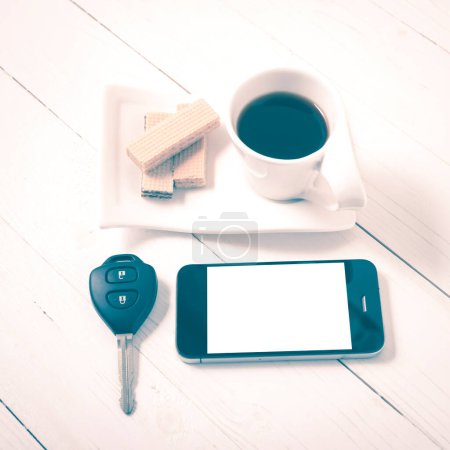 Photo for Coffee cup with wafer,phone,car key vintage style - Royalty Free Image