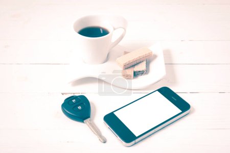 Photo for Coffee cup with wafer,phone,car key vintage style - Royalty Free Image