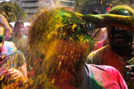 Photo for MALAYSIA, Kuala Lumpur: Revellers dance and spray colored powder during the Holi Festival in Kuala Lumpur on March 26, 2016 - Royalty Free Image