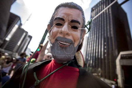 Photo for Brazil, Curitiba - March 26, 2016: Protesters in front of the Federal Court in Curitiba, Brazil on. Traditionally Saturday before Easter, Catholics beat effigies of Judas the apostle - Royalty Free Image