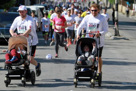 Photo for WEST BANK, Bethlehem: Runners push strollers during the 4th annual Palestine Marathon on April 1, 2016 in Bethlehem. - Royalty Free Image