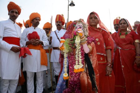 Photo for INDIA, Bikaner: Devotees take part in the traditional procession during the Gangaur festival at the Junagarh fort in Bikaner on April 10, 2016 - Royalty Free Image