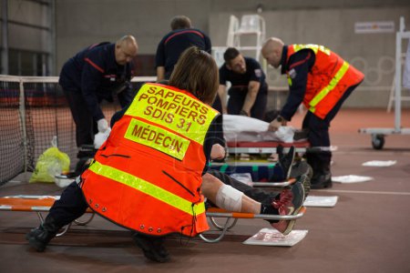 Photo for FRANCE, Toulouse: Civilians, medical staff, firemen and rescuers take part in a simulation exercise of terrorist attack at the Toulouse stadium on April 14, 2016 as part of the Euro 2016. - Royalty Free Image