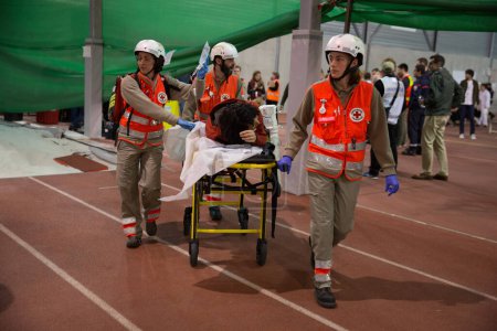 Photo for FRANCE, Toulouse: Civilians, medical staff, firemen and rescuers take part in a simulation exercise of terrorist attack at the Toulouse stadium on April 14, 2016 as part of the Euro 2016. - Royalty Free Image