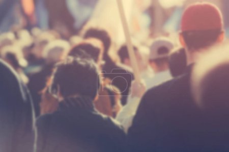 Photo for Blur unrecognizable crowd at a political meeting, cheering audience - Royalty Free Image