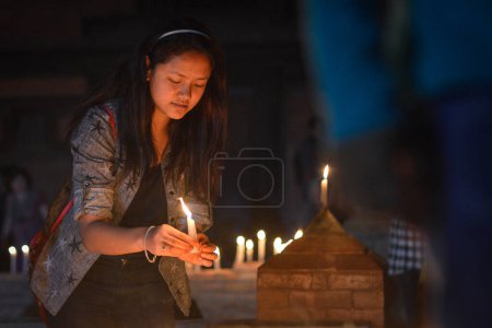 Photo for NEPAL, Patan: Nepalese residents gather to light candles during a vigil to mark the first anniversary of a devastating earthquake in Durbar Square in Patan, Kathmandu valley on April 24, 2016 - Royalty Free Image