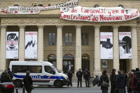 Photo for France, Paris - April 25, 2016: Policemen stand guard outside the Odeon theatre as French artists and entertainment workers known in France as intermittents du spectacle occupy the building - Royalty Free Image
