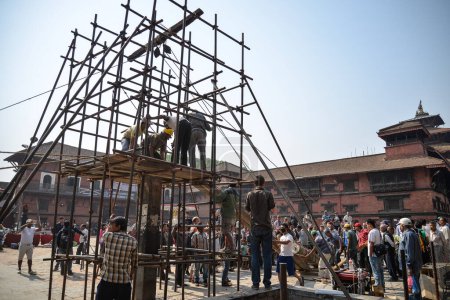 Photo for NEPAL, Kathmandu: Men begin rebuilding heritage sites damaged by the earthquake a year ago, on April 25, 2016, at Patan Durbar Square in Kathmandu, in Nepal, during the first anniversary of the quake - Royalty Free Image