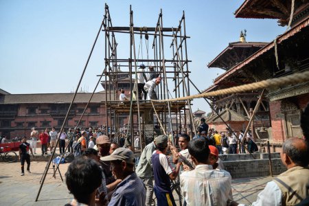 Téléchargez les photos : NEPAL, Katmandou : Des hommes commencent à reconstruire des sites patrimoniaux endommagés par le tremblement de terre il y a un an, le 25 avril 2016, sur la place Patan Durbar à Katmandou, au Népal, lors du premier anniversaire du tremblement de terre - en image libre de droit