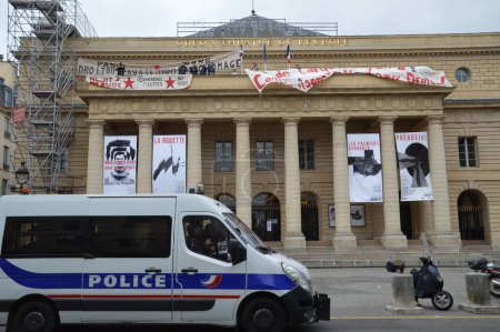 Photo for France, Paris - April 25, 2016: Policemen stand guard outside the Odeon theatre as French artists and entertainment workers known in France as intermittents du spectacle occupy the building - Royalty Free Image