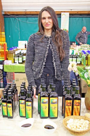 Photo for Fair Products of Croatian Village,girl sells pumpkin's oil,Zagreb,2016 - Royalty Free Image