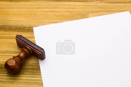 Photo for Wooden stamp and a sheet of paper - Royalty Free Image