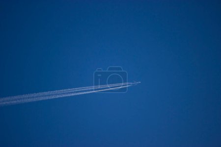 Photo for Plane Vapour crossing blue sky - Royalty Free Image