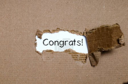 Photo for The word congrats appearing behind torn paper. - Royalty Free Image