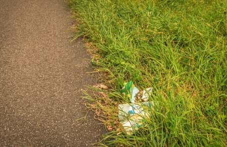 Photo for Trash on the side of the road in the grass - Royalty Free Image