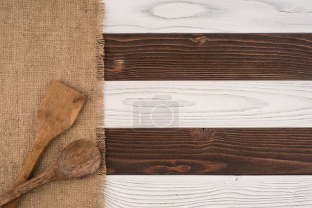 Photo for Spoon and spatula on old wooden table. - Royalty Free Image