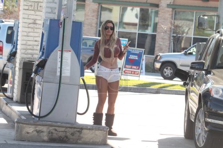 Photo for Ana Bragathe Brazilian Playboy Playmate spotted wearing tiny shorts and getting gas, Studio City, CA - Royalty Free Image