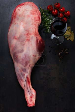 Photo for Raw lamb leg with glass of wine and vegetables - Royalty Free Image
