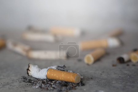 Photo for Cigarettes on the floor background view - Royalty Free Image