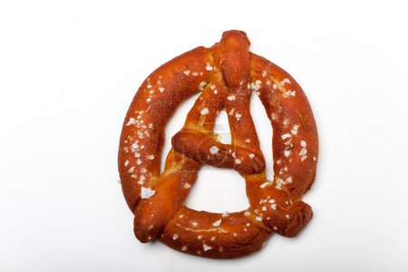 Photo for Bavarian pretzel in the shape of the anarchy sign - Royalty Free Image